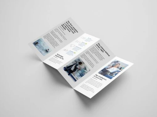 Mockup of a folded ZEISS Vision print brochure on a light grey surface